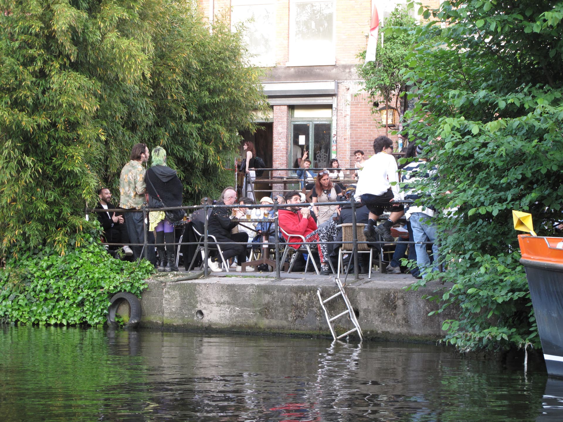 A canal side terrace with a ladder into the water
