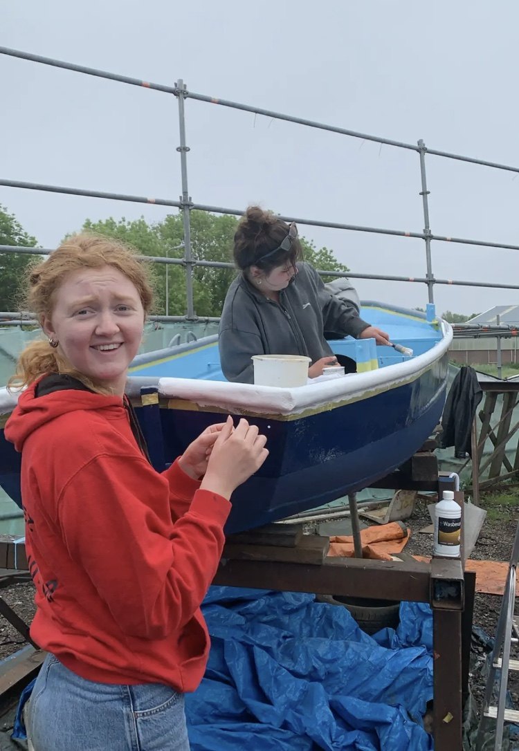 Painting the blue hull together at the yard