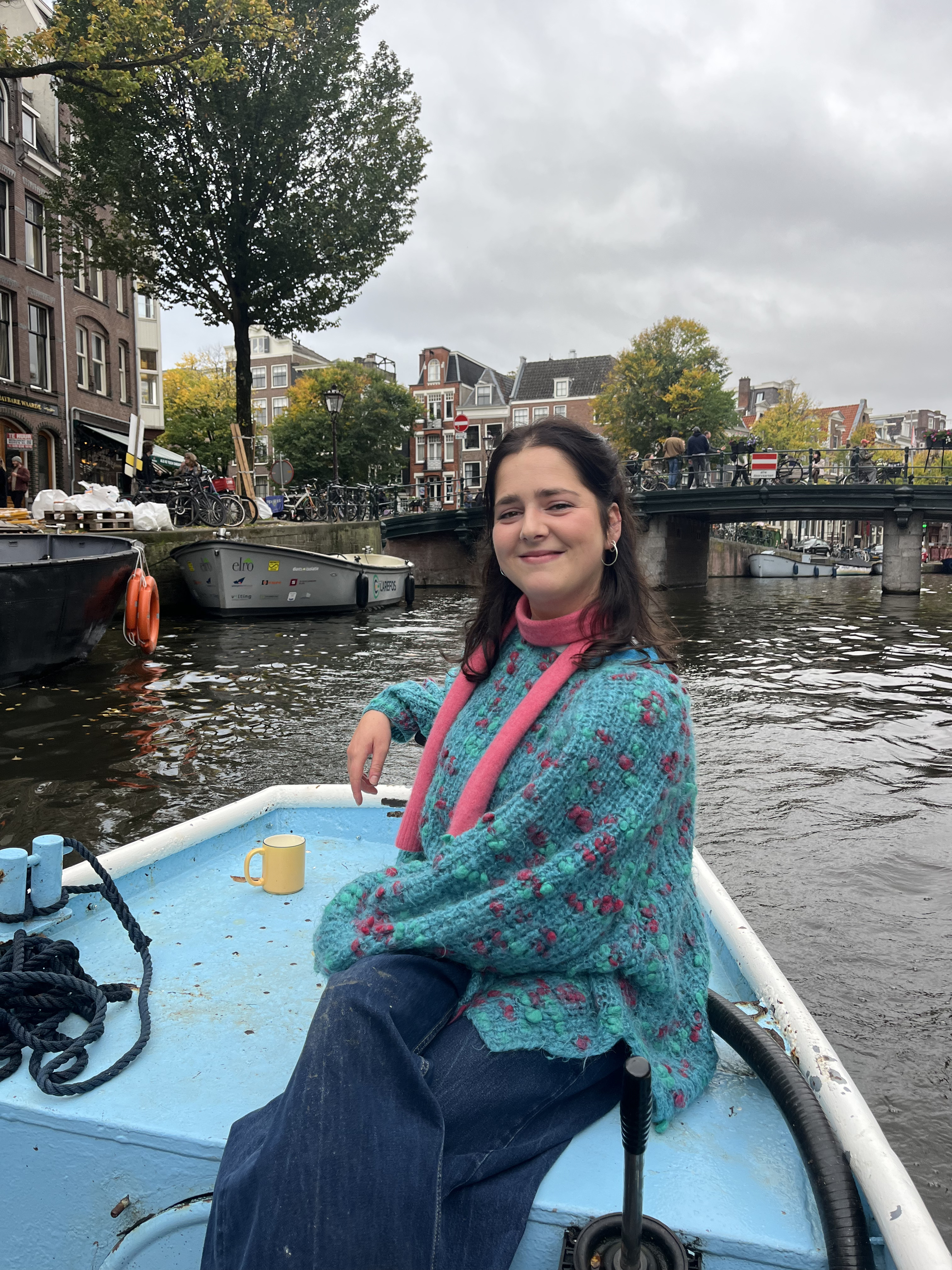Isabelle on a small boat in an Amsterdam canal